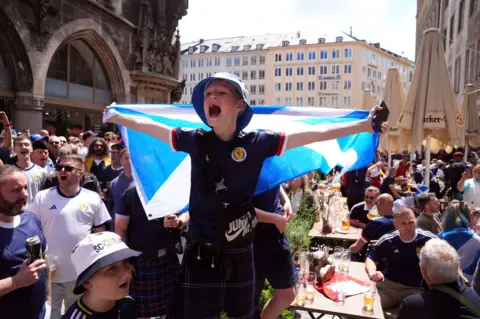 PA Young fan with a flag sings