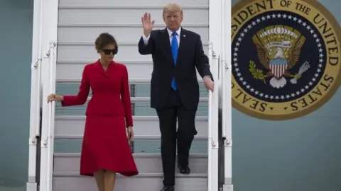 EPA Melania and Donald Trump disembark Air Force One in Orly, near Paris on 13 July 2017.