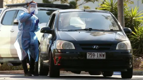 EPA A health worker at a drive-through testing centre in Brisbane