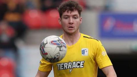 Rory Feely of Barrow is playing in the Sky Bet League 2 match between Doncaster Rovers and Barrow at the Keepmoat Stadium in Doncaster, on April 20, 2024.