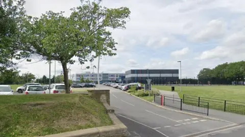 The front of Whitcliffe Mount School in Cleckheaton, from the view of the entrance to its car park.