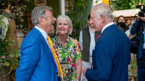 PA Media King Charles speaks to Alan and Alison Titchmarsh during a visit to the RHS Chelsea Flower Show at the Royal Hospital Chelsea in London.