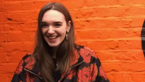 Bláithín Carroll Bláithín Carroll poses against an orange brick wall