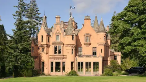 Simon Kennedy Aldourie Castle - a large mansion house-type castle with lots of Scottish baronial style turrets