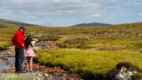 Anna Holligan's brother and her daughter in the Scottish Highlands