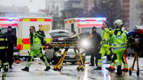 Paramedics with a stretcher at the scene of the attack 