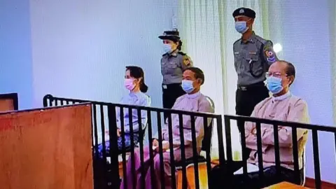 Myanmar State TV Aung San Suu Kyi in a makeshift courtroom with two other former leaders, 24 May 2021