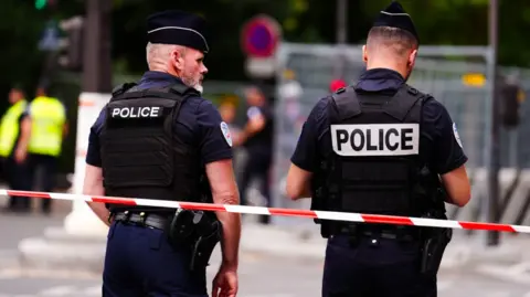 PA Media Perimeter fencing is patrolled by Police near the River Seine, Paris