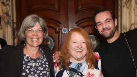 Alliance Party leader Naomi Long (centre) with newly elected Tara Brooks (left) and Micky Murray (right) at Belfast City Hall