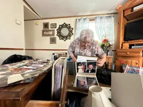 Nancy Berry attentively looks at her family photo album