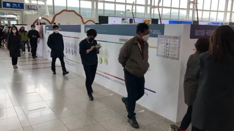 Voters queuing in South Korea