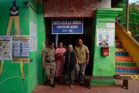 NurPhoto via Getty Images Pauline George, 87, exits a polling station after casting her vote during the Kerala state assembly election in Kochi, India, on April 9, 2026.