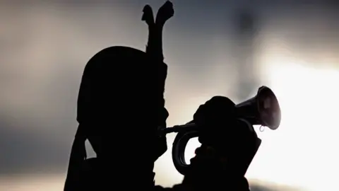 Jeff J Mitchell A bugler plays at George Square, as people gathered to pay tribute to those who lost their lives during conflicts on November 11, 2009