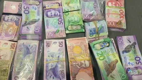 New Zealand Police NZ$100,000 seized by police officers.