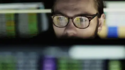 Getty Images Young man working at a computer screen