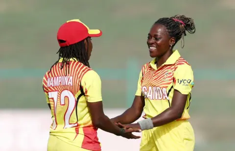 FRANCOIS NEL/GETTY IMAGES Ritah Musamali of Uganda celebrate with teammate Stephanie Nampiina after taking the wicket of Hasini Perera of Sri Lanka (not pictured).