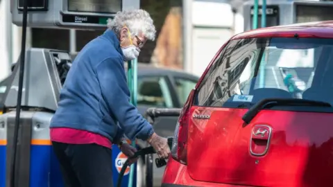 Getty Images Woman filling up car with petrol