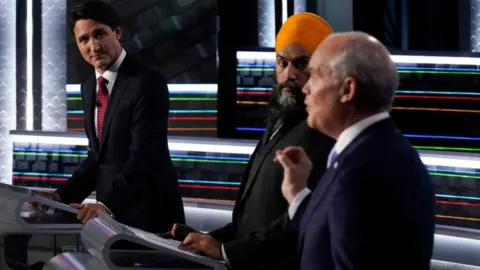 Getty Images Canadian Prime Minister and Liberal Leader Justin Trudeau (L), NDP Leader Jagmeet Singh (C) and Conservative Leader Erin O'Toole (R) participate in the federal election English-language Leaders debate in Gatineau, Quebec, Canada on September 9, 2021