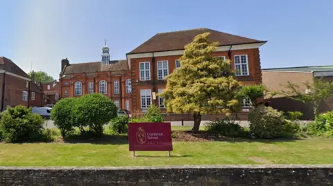 A google maps image of a brick built school building with a maroon sign reading Cranbrook School placed on green lawns at the front of the building