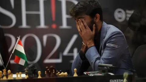 How Hwee Young/EPA Chess grandmaster Gukesh Dommaraju of India reacts after winning Game 14 against Ding Liren (not pictured) of China at the FIDE World Chess Championship in Singapore, 12 December 2024.