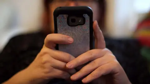 Stock image of a woman on her mobile phone