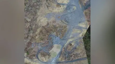 South Wales Police An aerial photo provided by South Wales Police showing motorbike tracks across a coal tip in Rhondda Cynon Taf.