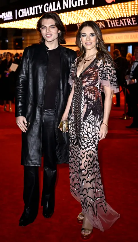 Gareth Cattermole/Getty Images Elizabeth Hurley (right) and son Damian Hurley (left) on Dominion Theatre red carpet for The Devil Wears Prada The Musical