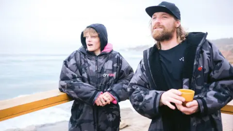 PA Media Ben and Lukas Skinner watching the sea