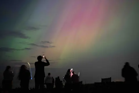 Getty People photographing the northern lights with their phones