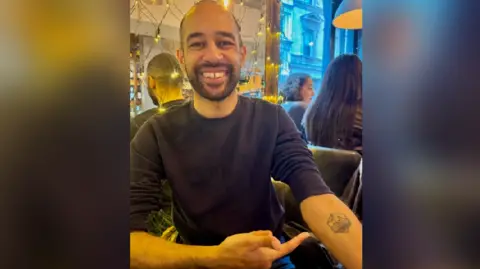 Lib Dem MP Josh Babarinde shows off his Eastbourne Pier tattoo