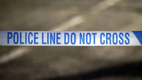  Police tape reading 'Police line do not cross'