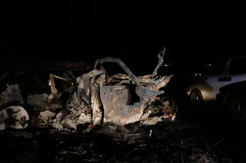 Afolabi Sotunde / EPA Wreckage of burnt vehicles following the explosion of a Compressed Natural Gas (CNG) truck near Karu Bridge in Abuja, Nigeria, 