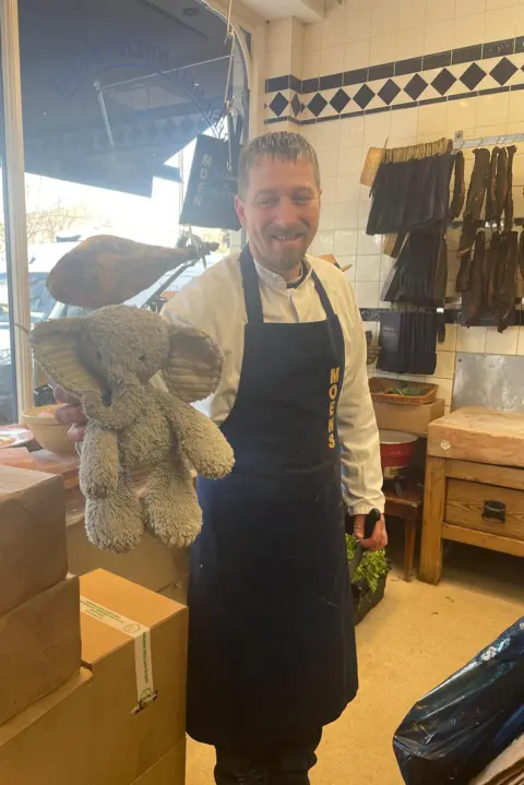 Catherine Wilson Matt Smith holds toy elephant inside butcher's