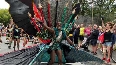 BBC The Carnival Queen led the parade through Leicester with crowds cheering for the city's 40th Caribbean Carnival in 2025.