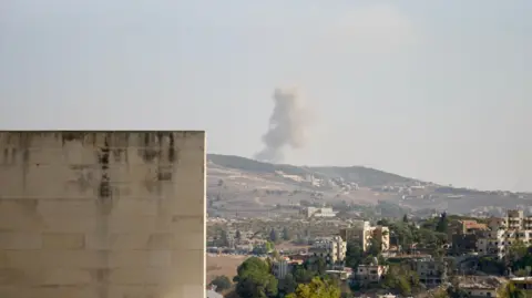 Goktay Koraltan From the hospital, smoke is visible rising over hills from the village of Arab Salim