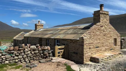 BBC The newly restored Burnmouth bothy has been renovated twice. In the 1970s, it was spruced up for a BBC adaptation, and during last winter, it was restored for a second time by a team of builders contracted by the Hoy Trust.