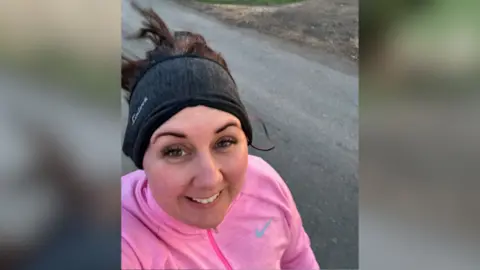 Family Handout Ms Battershall running in a pink jumper