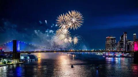 EPA Fireworks light up the sky over the Brooklyn Bridge during a fireworks display marking the 250th anniversary of US independence in New York, New York