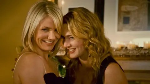 Sony Pictures via Alamy Cameron Diaz and Kate Winslet giggle together in Christmas classic, The Holiday