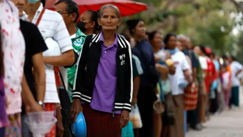 EPA Displaced Thai villagers who fled from homes following clashes between Thai and Cambodian troops, wait for food distribution