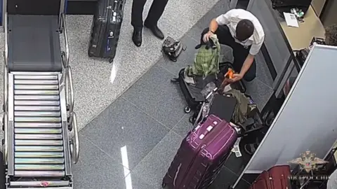 Russian Interior Ministry Fogel being searched at the airport