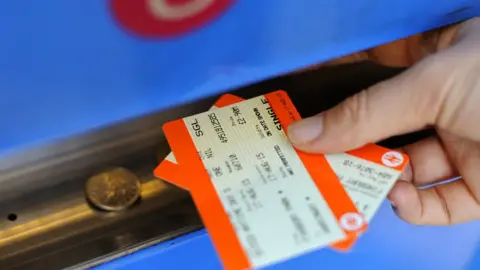 A person buying a train ticket