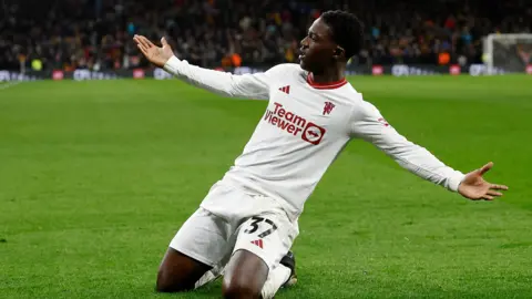 Reuters Manchester United's Kobbie Mainoo celebrates scoring against Wolverhampton Wanderers in February 2024