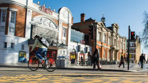 Getty Images An exterior view of people passing in front of The Ritzy Cinema in Brixton. 