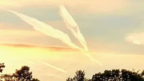 Caroline Turner Plane contrails in the sky