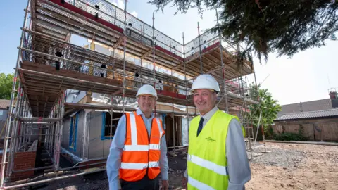 Gavin Ward, Morro Partnerships West Midlands operations director with councillor Steve Evans, deputy council leader on site at the development.
Both are stood in front the the building work with high-vis tops on over shirts and trousers.