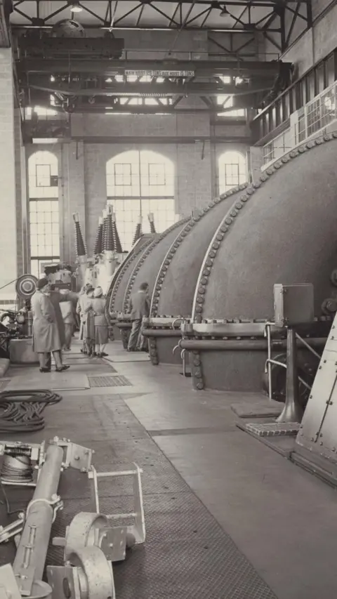 SSE Renewables Tummel power station's original turbines were large domes, several times taller than the people standing near them in a hall