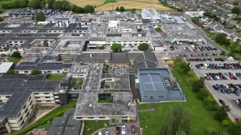 This is an aerial photograph of the old Airedale Hospital. It shows a large area of low-rise concrete buildings.