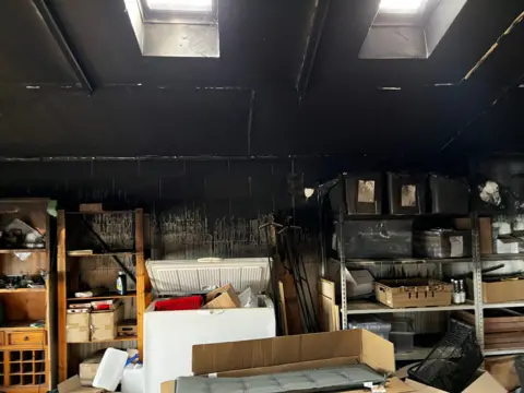 Photograph showing the damage caused to the garden centre building