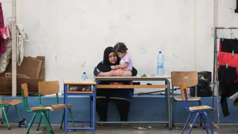 Reuters A woman talks with a child in a school turned into a temporary shelter for displaced people in Lebanon